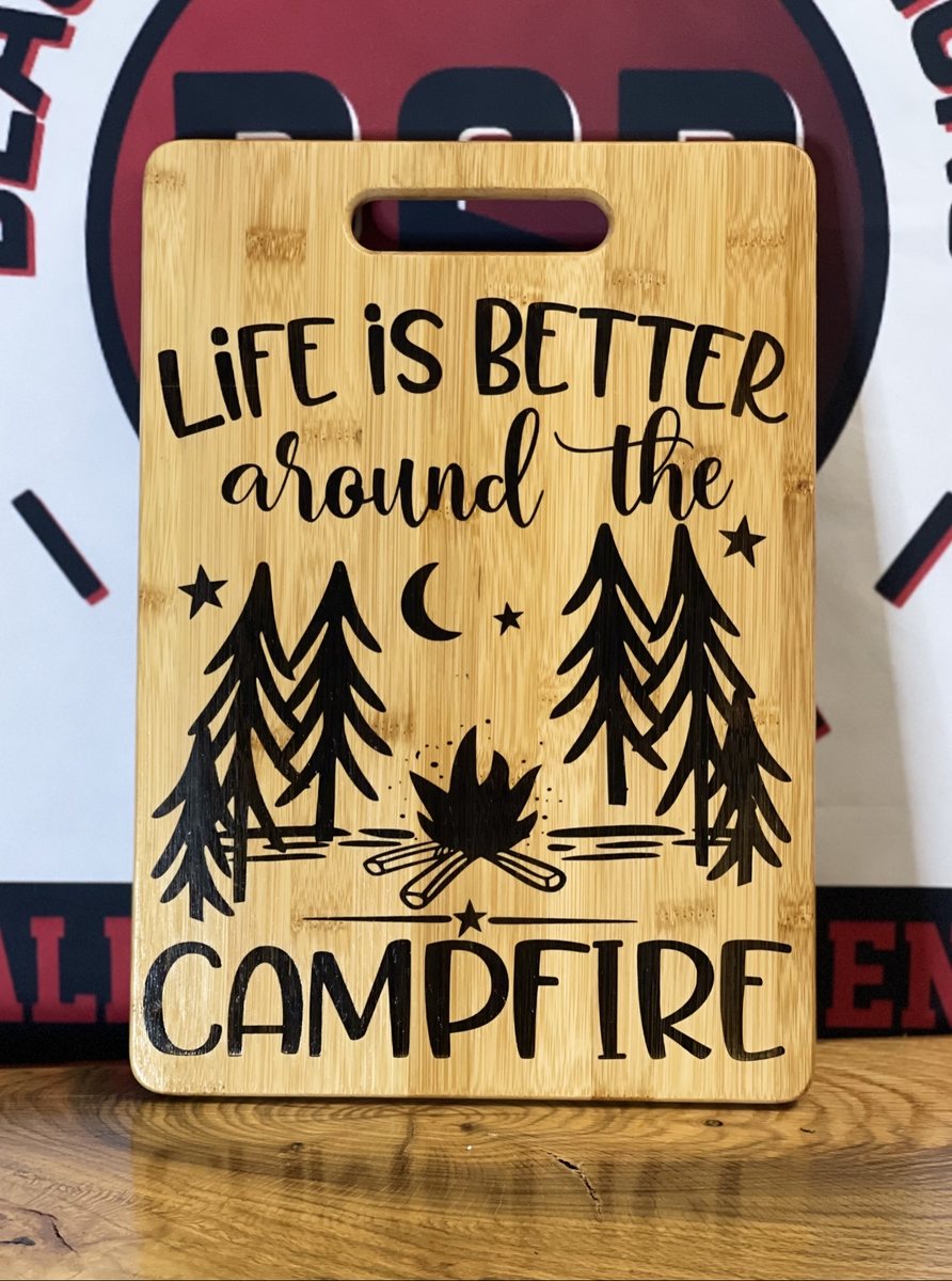 Bamboo cutting board engraved with a campfire scene