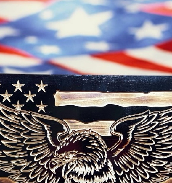 Close-up of a bald eagle carved into a wooden American flag