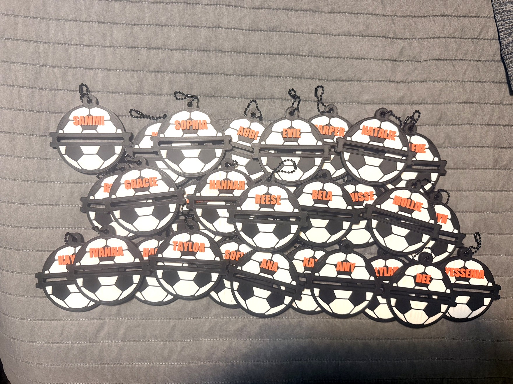 Personalized 3D-printed hair-tie holders made for a soccer team