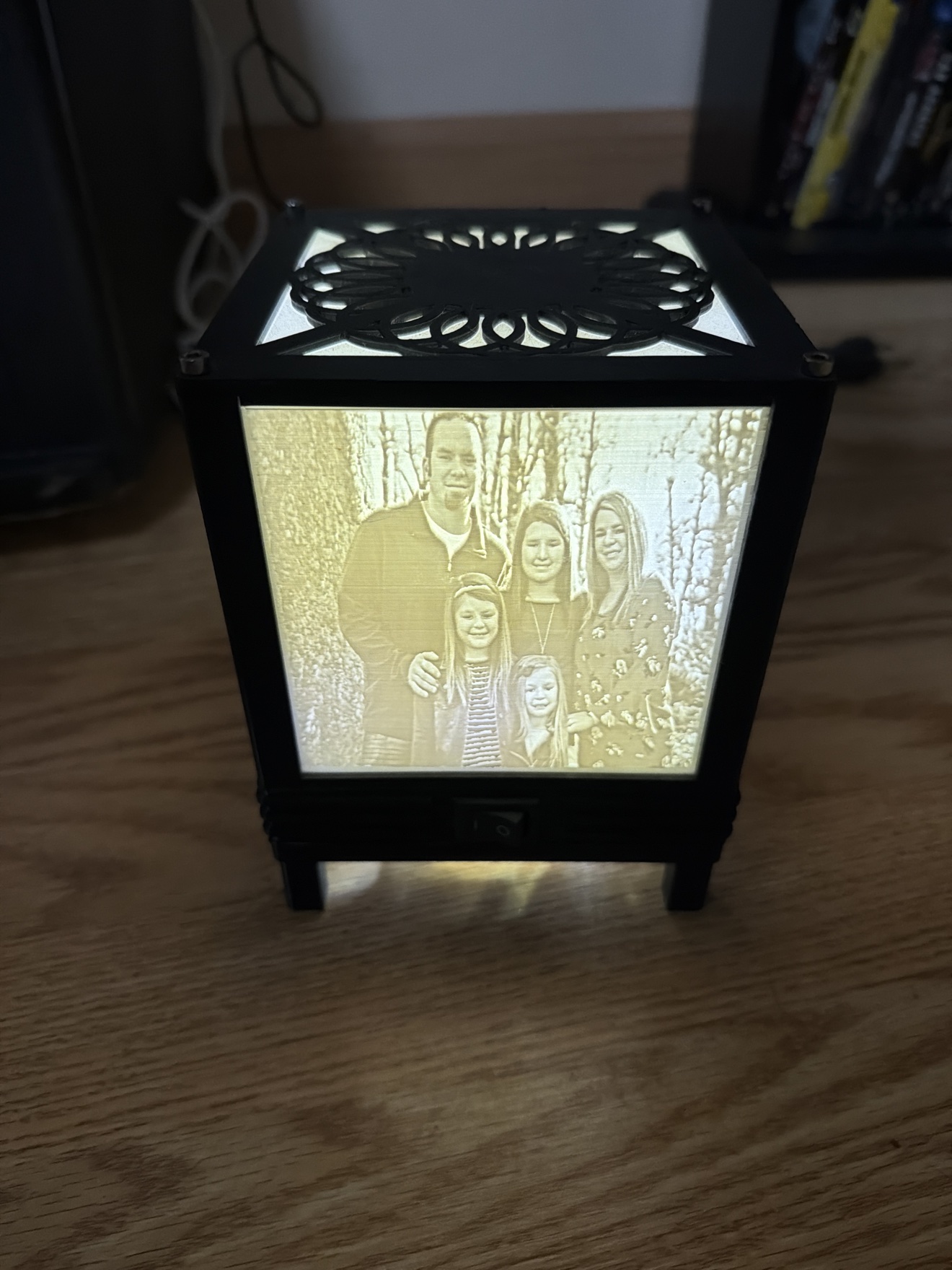 Custom 3D-printed lithophane light box glowing with a family photo