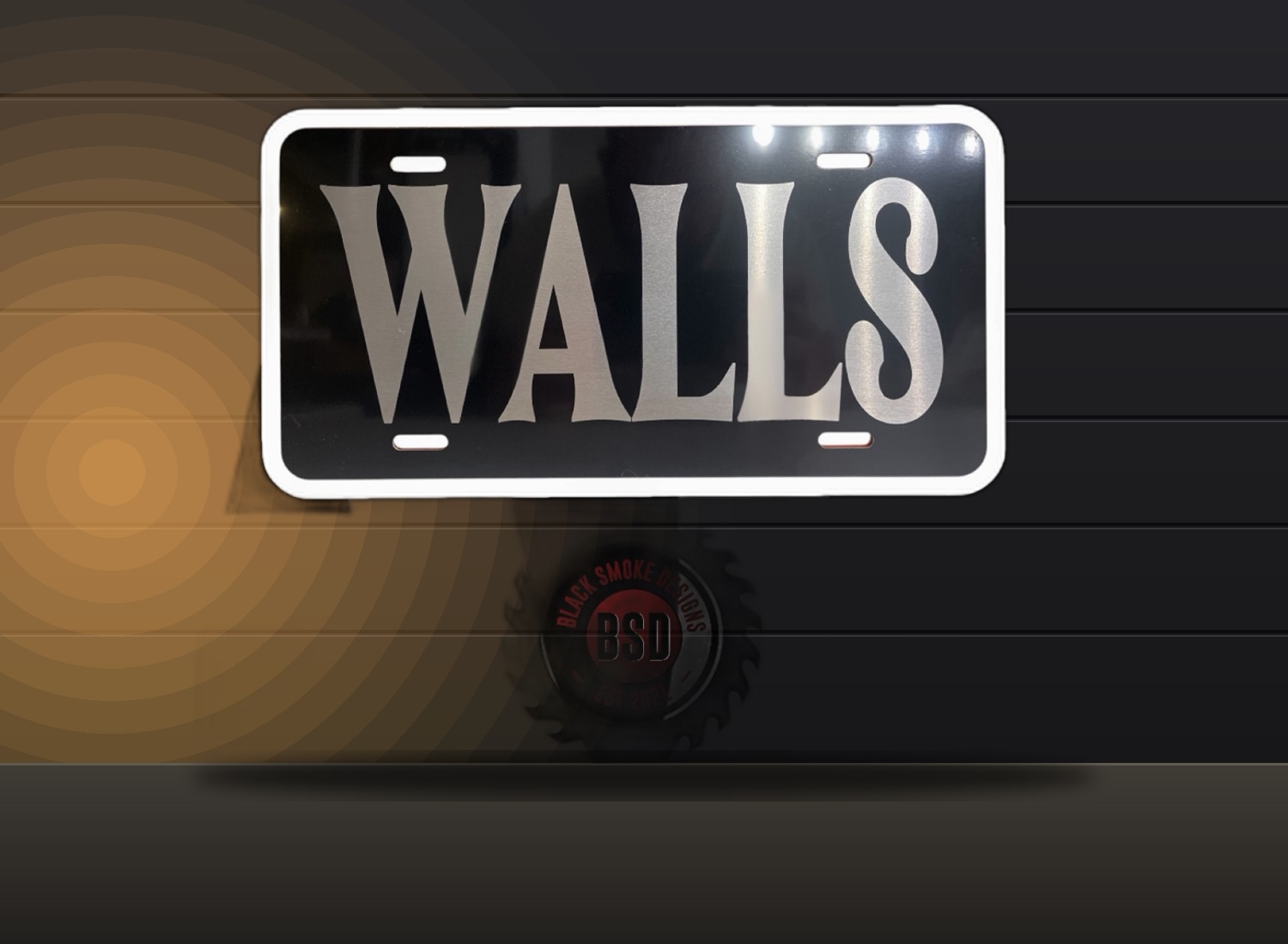 Glossy black license plate with silver custom lettering